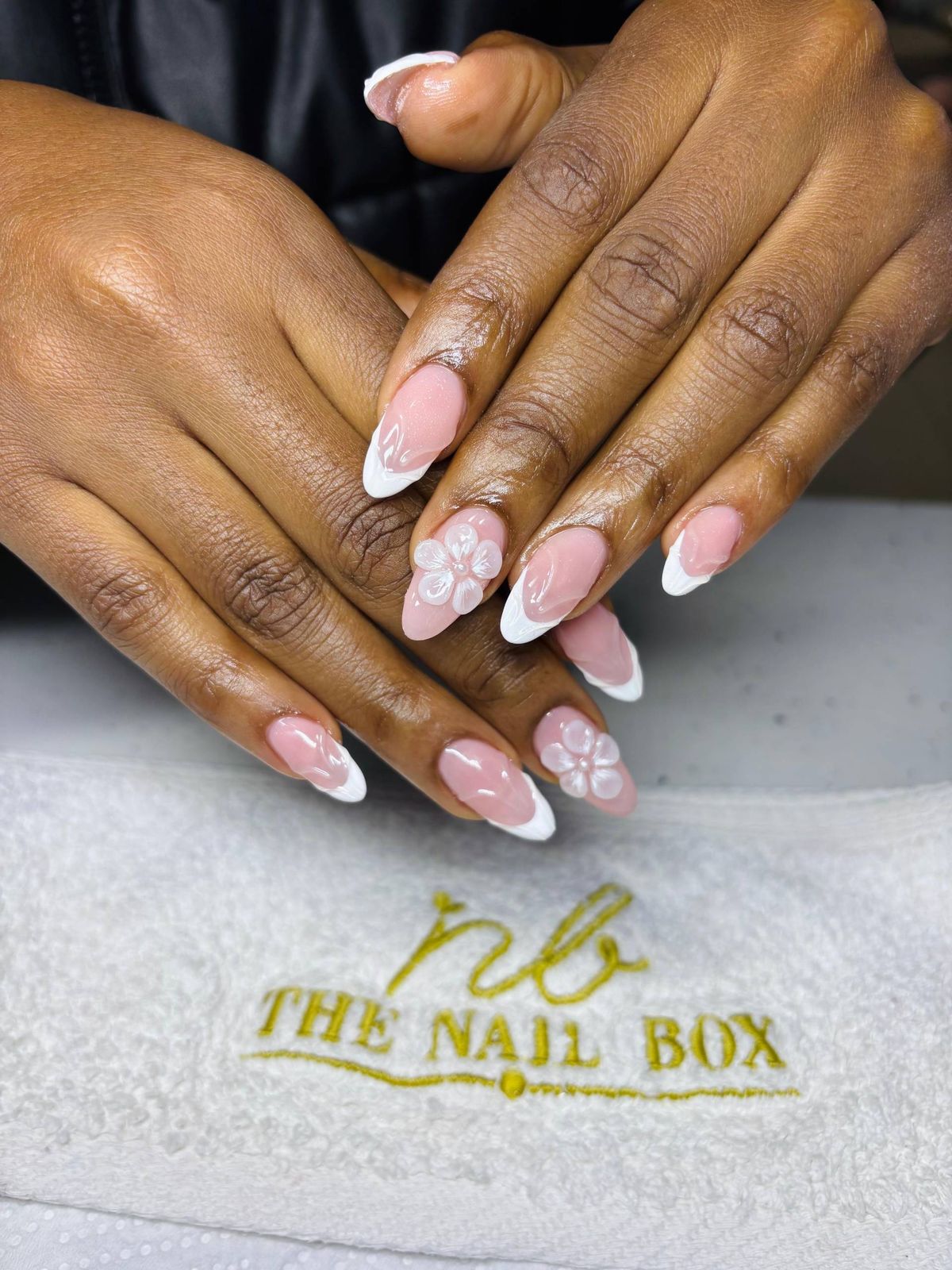 Sculpted acrylic almond nails finished in a soft nude by a Nail Box student